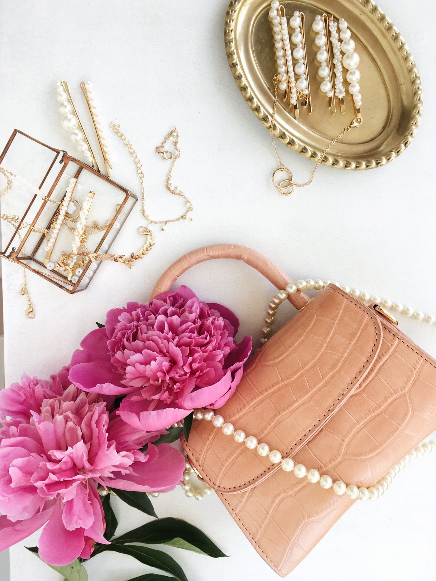 Pink handbag with flowers and pearl jewellery